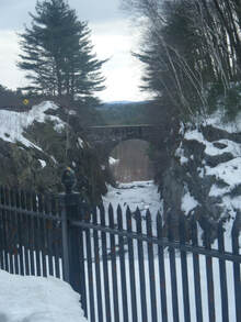 Dark overlook of snow-covered river and stone-bridge--'....the depths of shadows & evil....'