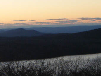 Orange sunset beyond lake & rolling-blue hills--'....the Lord restores my soul' 